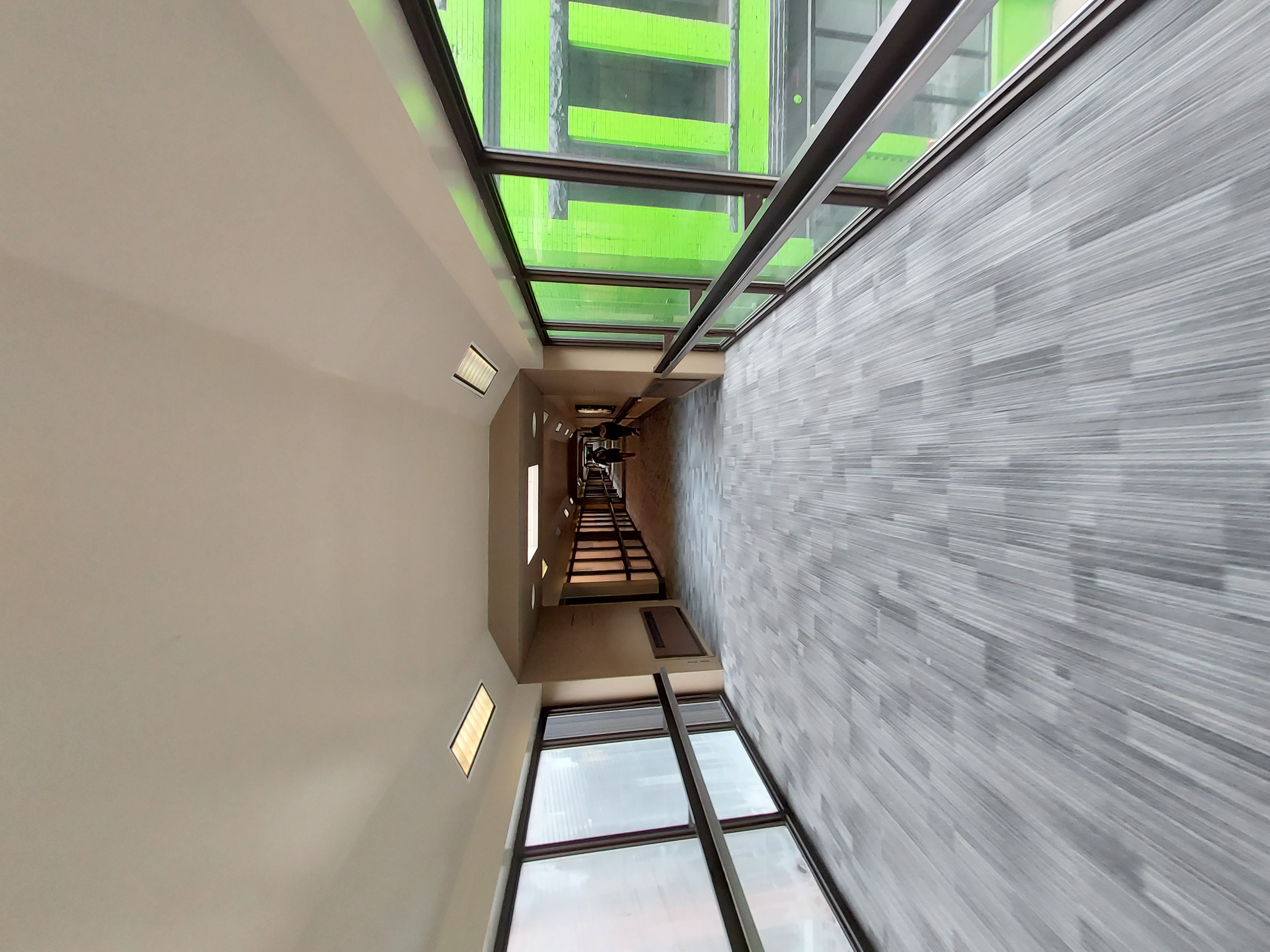 Students annotating the Spectacle / Media Fast assignment board with neon tape during a critique huddle